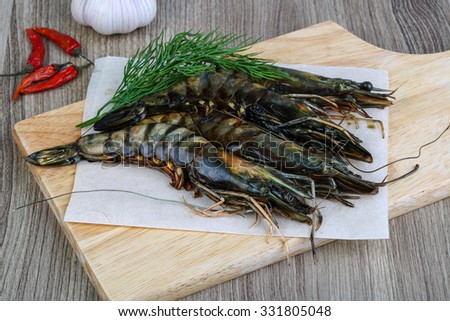 Raw tiger king shrimps ready for cooking with dill