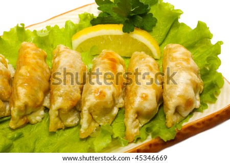Japanese Cuisine - Pork (or Seafood) Dumplings (gyoza). Garnished on Salad Leaf with Pepper and Fresh Parsley