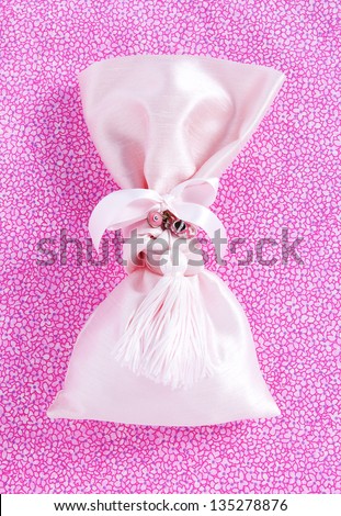 pink baptism sugared almonds for girl on floral background