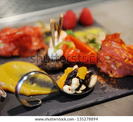 variety meats and vegetables with with a very beautiful shaped spoon close up