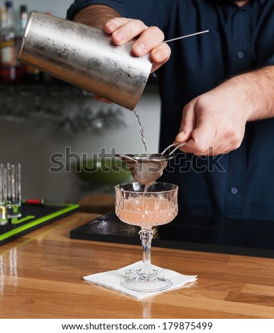 bartender making cocktails and serves a