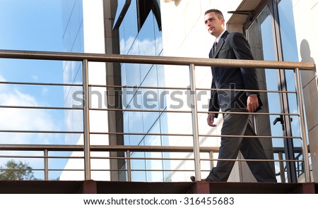 a security guard in do his patrol in  a outdoor corridor of a building