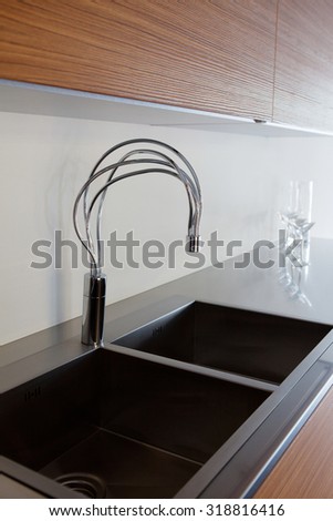as modern shape and design sink in a kitchen close up in a showroom