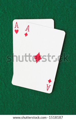 Ace of hearts and diamonds on a green background