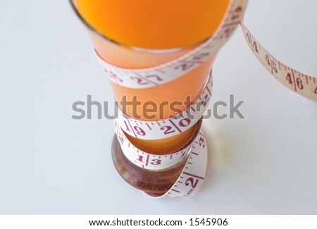 Top down view of vitamen drink and measuring tape