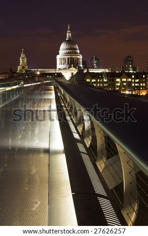 Millennium Bridge and St Paul\'s cathedral with ghostly figures passing the camera as it captures the image.