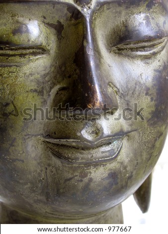 A serene bronze Buddha's face