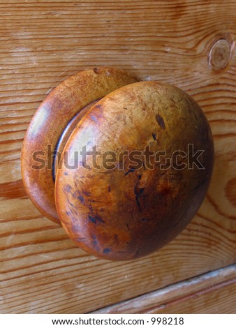 A drawer knob on an old pine cabinet
