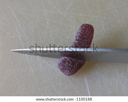 Slicing the head off a jelly worm - animal testing or vivisection motif