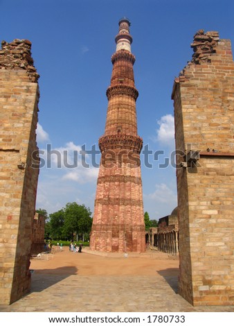 The huge monument to the arrival of Islam in India, Qutab Minar, towers over visitors in Delhi.