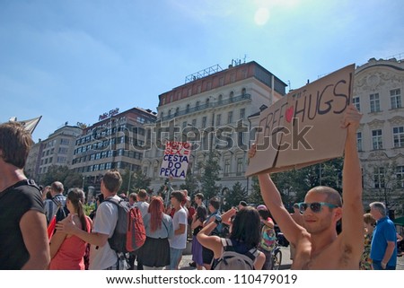 PRAGUE, CZECH REPUBLIC - AUGUST 18: Participant of the 2. Prague Pride Parade offers free hugs + a counter-protester with a sign \
