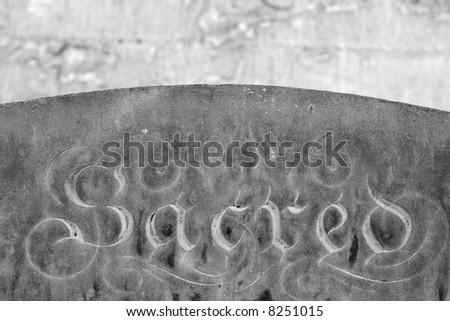 black and white image of a grave stone with the word \