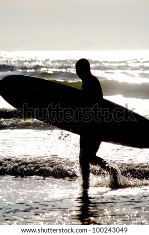 surfing at a nice beach outside at the sea