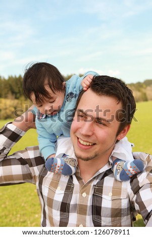 A young happy father 25 years with his 4  month old son.