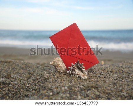 Decorative red  envelope on sand background
