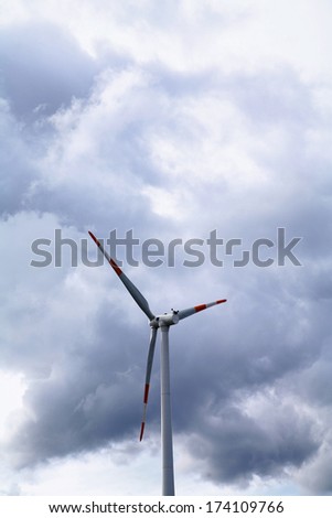 electric wind mill against the sky