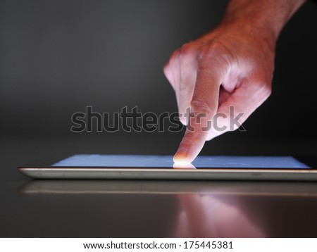 hand presses on screen digital tablet