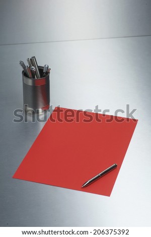 pen paper on metal desk surface