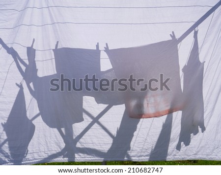 clothes hanging on a clothes drying rack on a sunny day