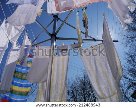 clothes hanging on a clothes drying rack on a sunny day
