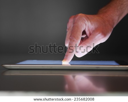 hand presses on screen digital tablet
