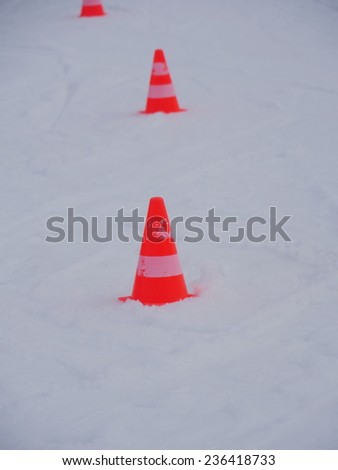 red white striped cones on the snow