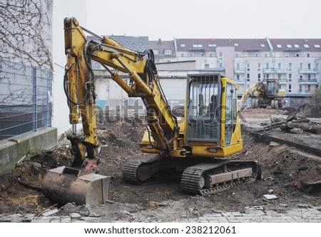 Excavator or digger on an urban building site being used for earthworks and clearing the site for construction