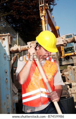 Close-up of a worker digging at building site
