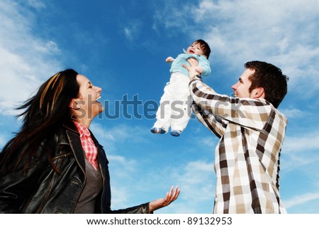 A young happy family with their 4  month old son