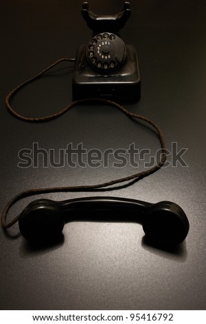 an old vintage telephone in dramatic lighting.