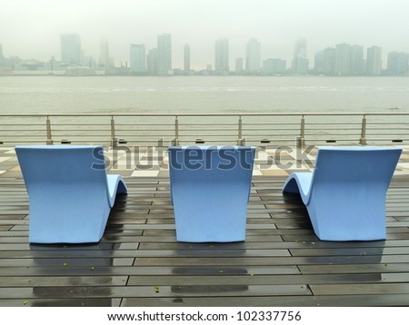 lounge chairs facing New Jersey on a rainy day