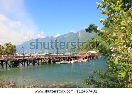 Vancouver Island wooden mooring and summer mountain forest landscape. (Vancouver Island,British Columbia,Canada)