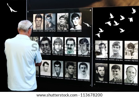TEL-AVIV, ISRAEL - SEPTEMBER 06: Elderly man looks at old photos of Israeli soldiers lost in wars. Meeting of veterans of Paratroopers Brigade on September 06, 2012 in Tel-Aviv, Israel