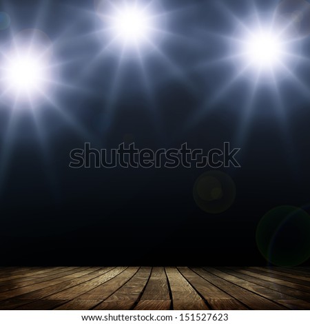 Spots lighting over dark background and wood floor