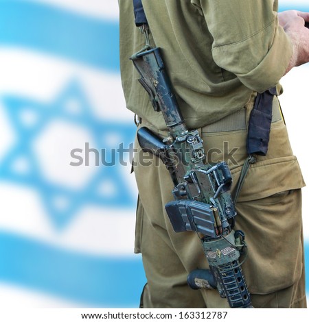Soldier of Israeli defense forces on the Israeli flag bokeh background. Close up