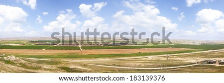 Panoramic view on spring agriculture valley - green fields,arable land and fruit plantations in the Negev desert, Israel