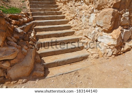 Sand stone ladder with wooden steps. Mediterranean