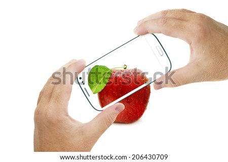 Hands holding touch screen smart phone and taking red apple picture. Isolated on white background