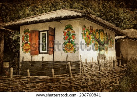Textured old grunge paper background with national traditional ancient ukrainian rural house.  Vintage style