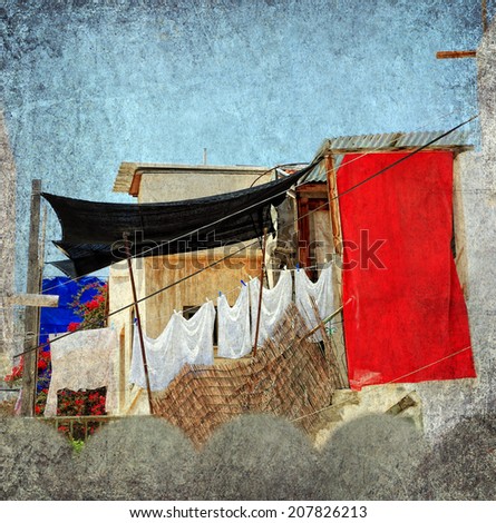 Textured grunge paper background with laundry line and clothes in the old yard of the Mediterranean. Vintage style
