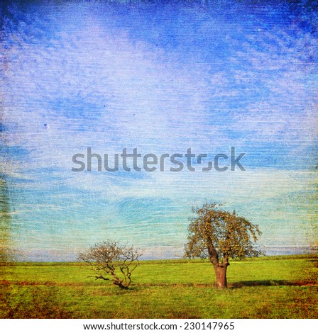 Trees on the meadow sky pastoral landscape. Paper and wood texture. Aged textured photo in retro style