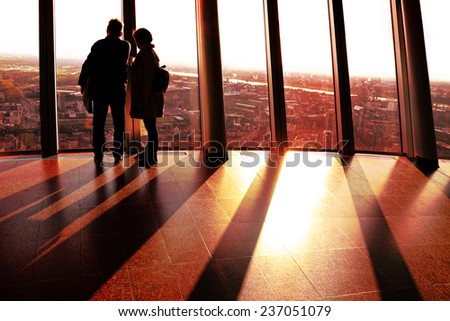 GERMANY,DUSSELDORF- OCTOBER,10:Silhouettes of people on Rhine Tower observation point at sunset.Rhine Tower - 240.5 meter,the best rotating view point for town supervision,Germany ,on October 10,2014