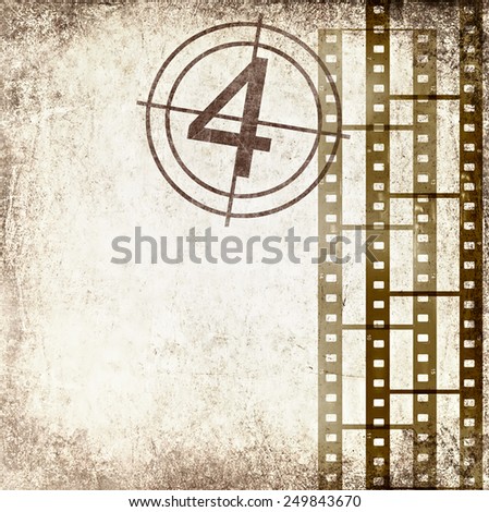 Textured old paper background with films strips and film number. Vintage film stripe cinema abstract background. Image done in retro style with effect of sepia