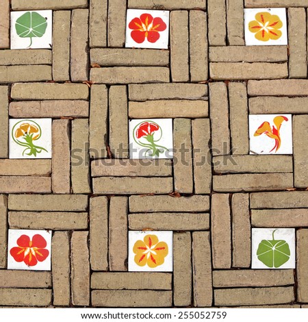 Old pavement cobblestone background. Road flower mosaic pattern. Road tiles