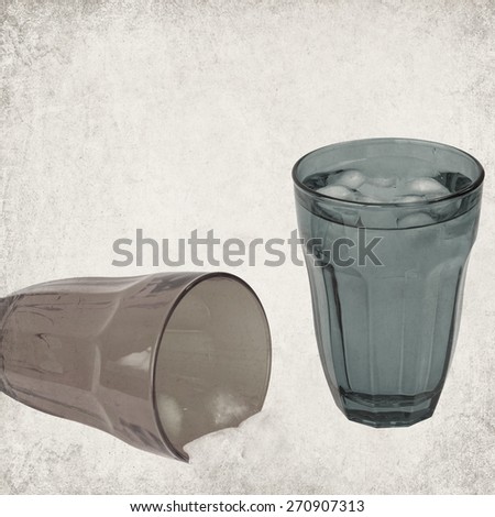 Textured old paper background with drink glass with ice cooled drink