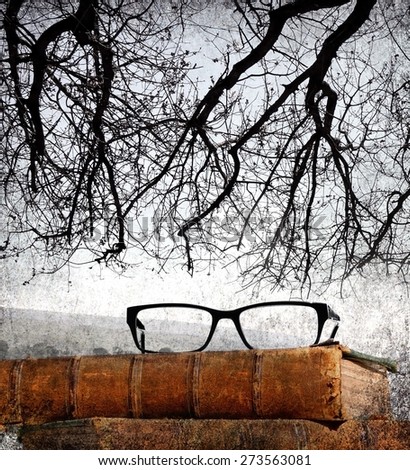Nature, knowledge and vision concept - Ancient books and eye glasses in the foreground with branches of an old tree and a distant landscape in a background. Vintage style. Old paper texture