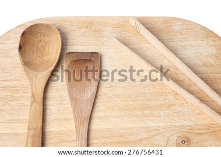 Different wood kitchen tools on the old wood kitchen cutting board. White background