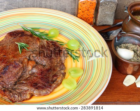 Meat (low fat beef steak) with herbs and grapes of Mediterranean cuisine