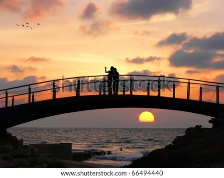 people silhouettes standing. people silhouettes standing. of two people standing on