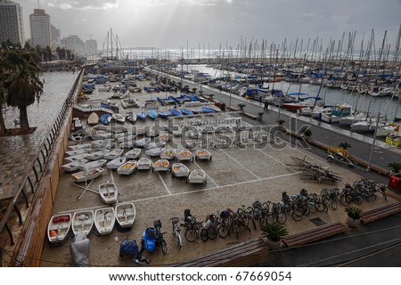 Storm by the Mediterranean sea and yachts in a marina